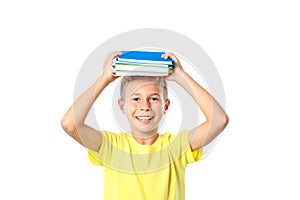 Boy in yellow t-shirt with copybooks isolated