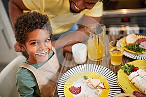 Boy with yogurt moustache having dinner