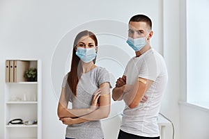 boy and young woman with injections on hands medical mask hospital immunity covid-19 passport