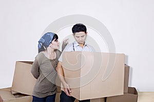 Boyfriend bring box on white with angry girlfriend