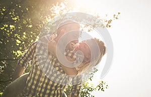 Boyfriend carries the girl on her back with open arms.