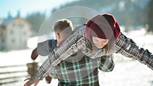 The Boyfriend Carries Girl on His Back. Romantic Couple is Having Fun Outdoors During Winter Time, Countryside and Blue