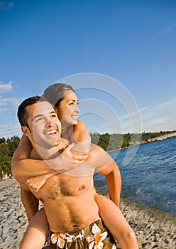 Boyfriend carrying girlfriend at beach