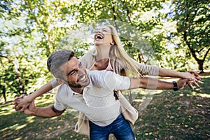 Boyfriend carrying his girlfriend on piggyback