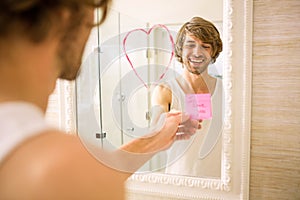 Boyfriend discovering a love message on the mirror