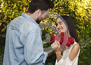 Boyfriend Giving Roses To Girlfriend On Valentine`s Day In Cafe