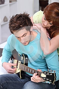 Boyfriend paying the guitar