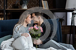 boyfriend presenting bouquet of roses to happy girlfriend