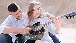 Boyfriend teaching girlfriend how to play song in career