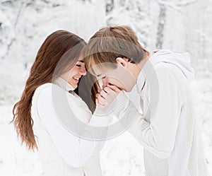 Boyfriend warms hands sweetheart, frozen in the cold photo