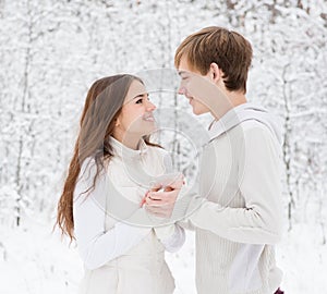 Boyfriend warms hands sweetheart, frozen in the cold photo