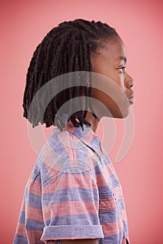 Boyhood identity. Profile shot of a young boy standing in studio.