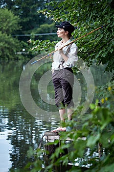 Boyish looking girl fishing outdoors