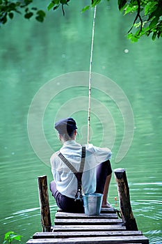 Boyish looking girl fishing outdoors