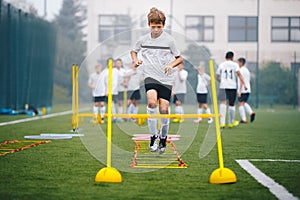 Boys on Agility Training on School Soccer Pitch. Athlete Soccer Player In Training