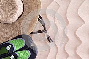 Boys beach hat and shoes on golden sand