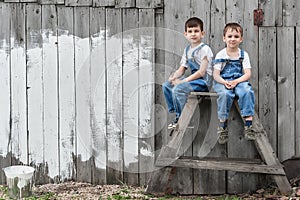 Boys with brushes and paint at an old wall