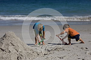 Boys building sand castles on the beach