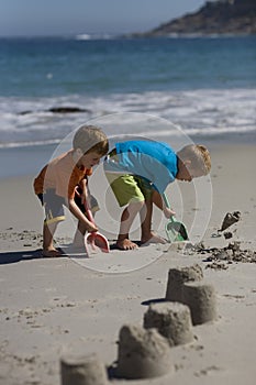 Boys building sand castles on the beach