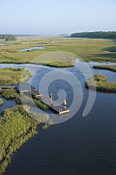 Boys on dock in marsh.