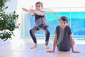 Boys doing sport exercises on balcony. Sport, healhty lifestyle, active leisure at home