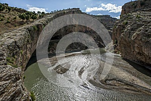 Boys are dwarfed by the enormous gorge carved out of the rock by the Cendere River near the town of Kocahisar in eastern Turkey.