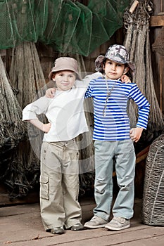 Boys - fishermen in a barn with fishing tackles