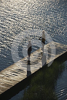 Boys fishing on dock.