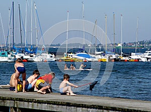 boys fishing on a pier