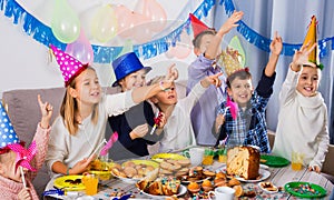 Boys and girls behaving jokingly during friend birthday party
