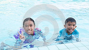 Boys and girls have fun playing in the pool