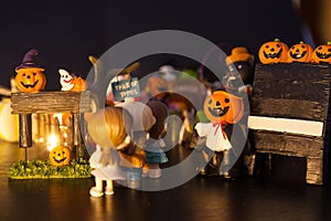Boys and girls queueing at pumpkin entrance with black blank signboard welcome to Halloween festival party house. Festive Celebrat