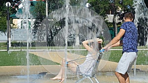 Boys girls rolled carts - a fountain in the summer