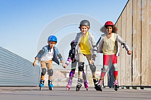 Boys and girls rollerblading at stadium outdoors