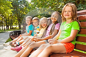 Boys and girls sitting on the bench in park