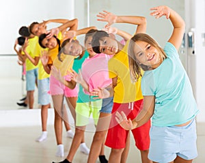 Boys and girls standing in row in dance room