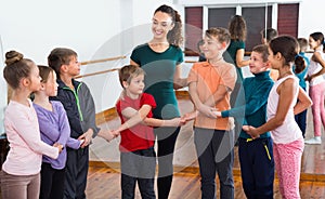 Boys and girls studying folk dance in studio