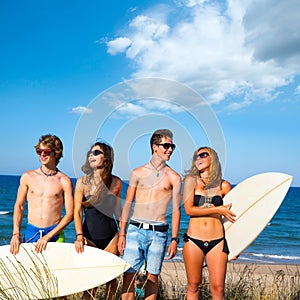 Boys and girls teen surfers happy smiling on beach