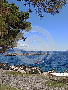 boys go canoeing along the coast of Suha Punta in Rab Island Croatia in a sunny day