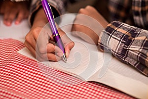 Boys' hand writing in notebook.