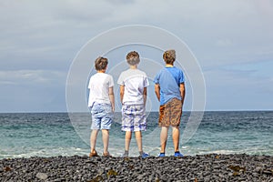 Boys have fun at the black volcanic beach