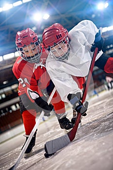 Boys hockey player handling puck on ice