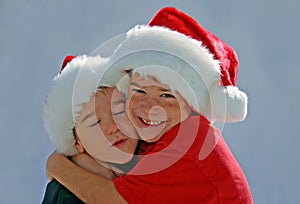 Boys Hugging with X-mas Hats On photo
