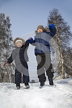 boys jump in winter outdoors