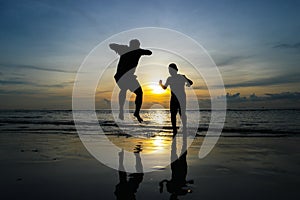 Boys jumping on the beach Sunset