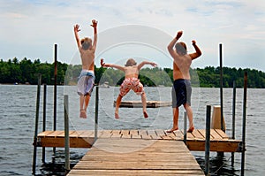 Boys jumping into lake