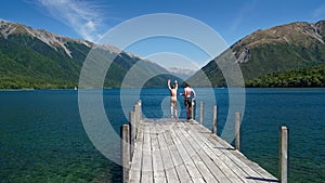 Boys jumping off the jetty at Lake Rotoiti, Nelson Lakes National Park, New Zealand