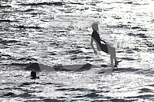 Boys jumping into the water - monochrome image