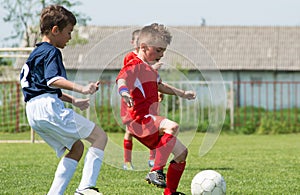 Boys kicking football