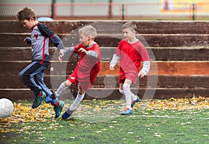 Boys kicking football